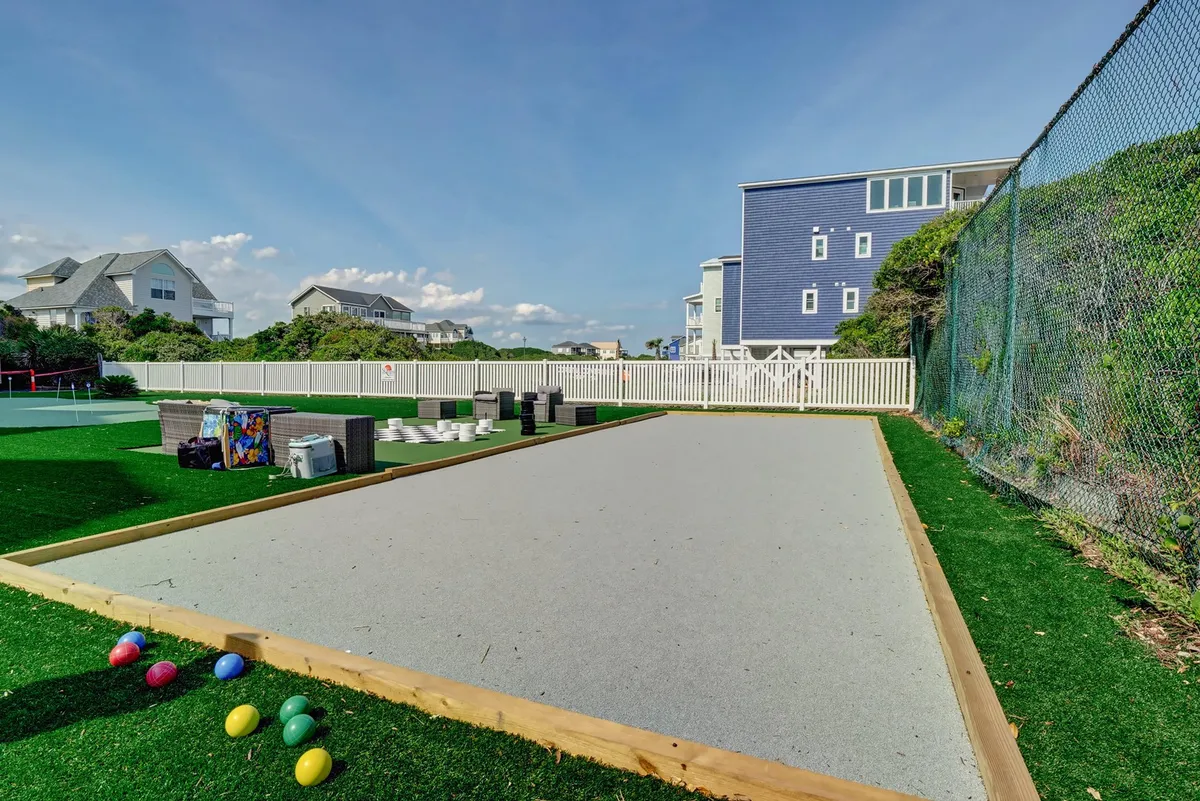 This image features a bocce ball court with colorful bocce balls and adjacent seating. The area is designed for casual play and gatherings, creating a playful, social atmosphere ideal for group enjoyment.